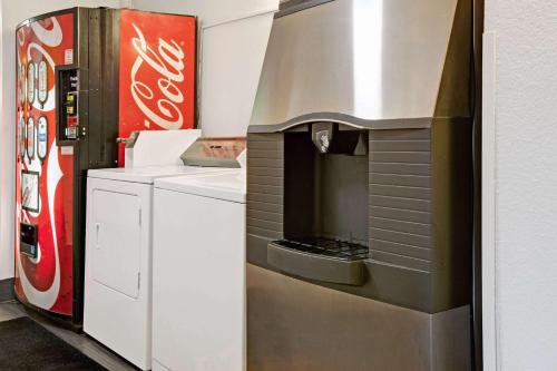 a kitchen with a coca cola refrigerator and a stove at Super 8 by Wyndham Baltimore/Essex Area in Essex