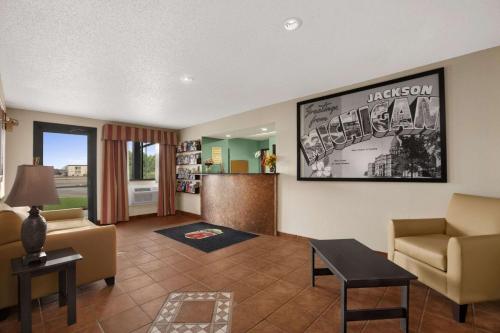 a living room with a couch and a chair at Quality Inn in Jackson