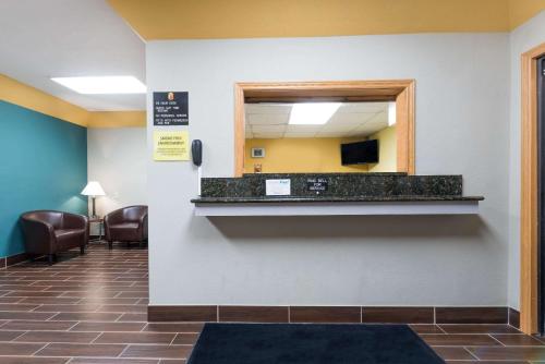 a waiting room at a hospital with a mirror at Super 8 by Wyndham Devils Lake in Devils Lake
