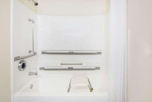a bathroom with a white tub and a sink at Super 8 by Wyndham Thurmont in Thurmont