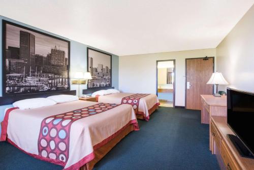a hotel room with two beds and a flat screen tv at Super 8 by Wyndham Thurmont in Thurmont