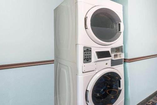 a washer and dryer in a room at Super 8 by Wyndham Warrensburg in Warrensburg