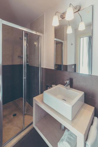 a bathroom with a white sink and a shower at Il Piccolo Giardino GH ***Superior in Taormina
