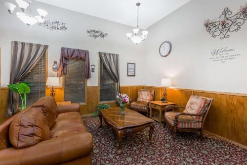 a living room with a couch and chairs and a table at Super 8 by Wyndham Manhattan KS in Manhattan