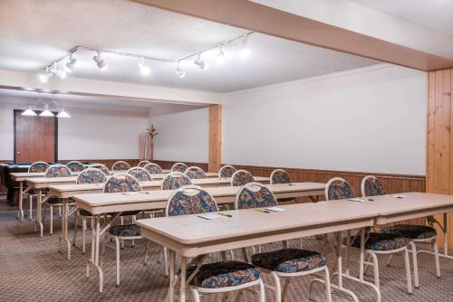 a classroom with rows of tables and chairs at Super 8 by Wyndham Baxter/Brainerd Area in Baxter