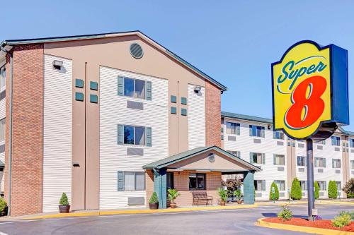 a building with an sign in front of it at Super 8 by Wyndham Louisville Airport in Louisville