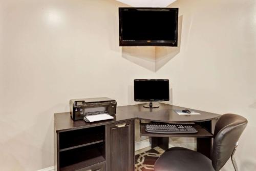 an office with a desk with a computer and a printer at Super 8 by Wyndham Louisville Airport in Louisville