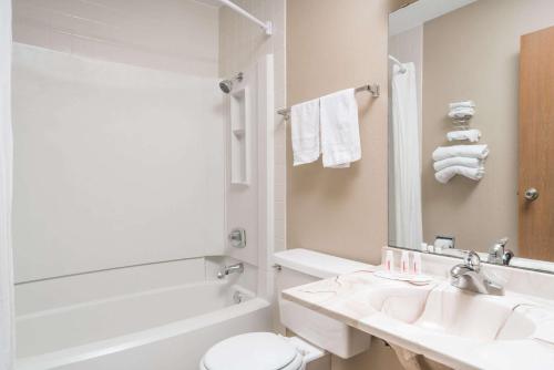 a bathroom with a sink and a toilet and a tub at Super 8 by Wyndham Baxter/Brainerd Area in Baxter