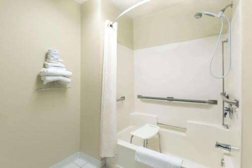 a bathroom with a shower and a toilet and a sink at Super 8 by Wyndham Perham in Perham