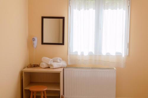 a room with a radiator and a window with a mirror at La Casa Di Nonna in Argostoli