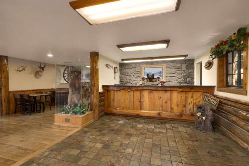 a lobby with a bar and a stone wall at Super 8 by Wyndham Jackson Hole in Jackson
