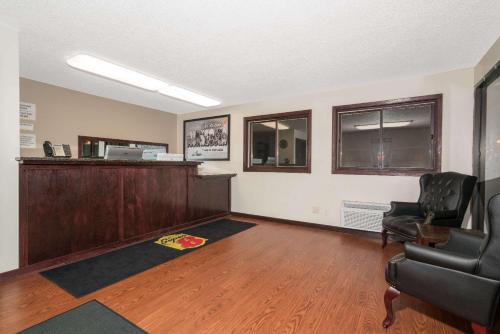 a waiting room with a desk and two chairs at Super 8 by Wyndham St. Cloud in Saint Cloud