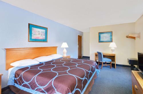 a hotel room with a bed and a desk at Super 8 by Wyndham Newburgh/West Point Stewart Intl Airport in Newburgh