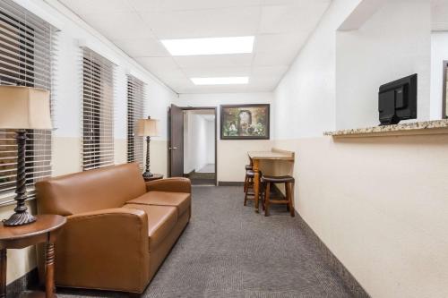 a living room with a couch and a desk at Super 8 by Wyndham Montgomery Maybrook in Montgomery