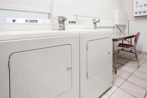 a washing machine in a room with a table at Grizzly Inn in Great Falls