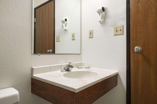 a bathroom with a sink and a mirror at Brookville Inn in Brookville