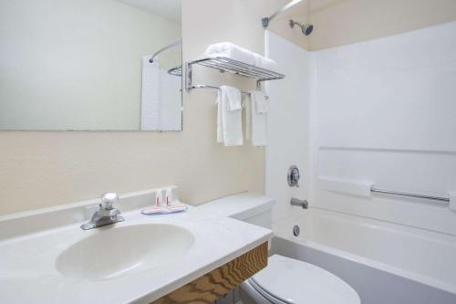 a white bathroom with a sink and a toilet at Super 8 by Wyndham Radford VA in Radford