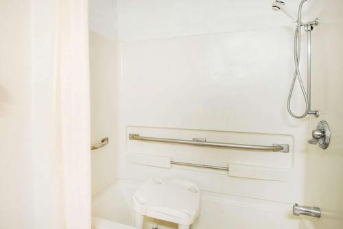 a bathroom with a toilet and a shower at Super 8 by Wyndham Pittsburgh PA Airport-University Area in Moon Township