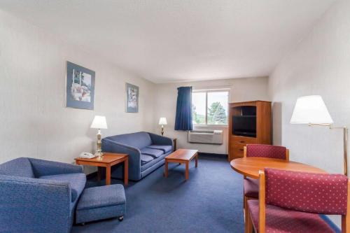 a living room with a couch and a table at Super 8 by Wyndham Sidney NY in Sidney
