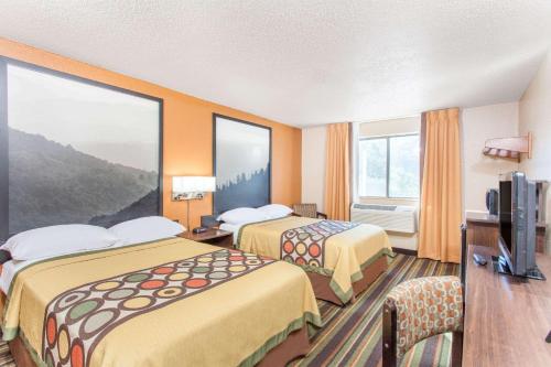 a hotel room with two beds and a television at Super 8 by Wyndham Norton VA in Norton