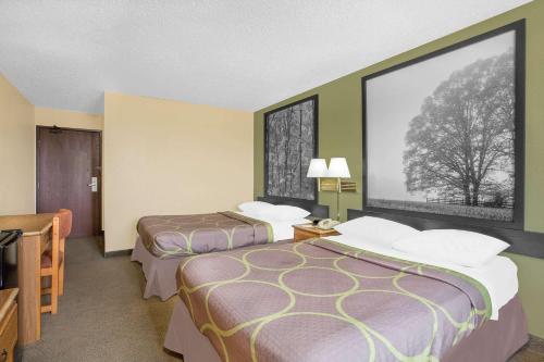 a hotel room with two beds and a large window at Super 8 by Wyndham Roanoke VA in Roanoke