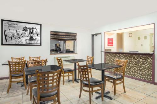 a dining room with tables and chairs in a restaurant at Super 8 by Wyndham Abingdon VA in Abingdon