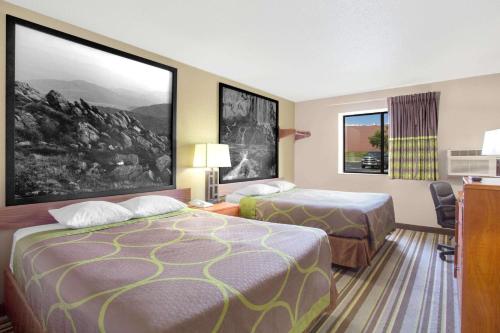 a hotel room with two beds and a desk at Super 8 by Wyndham Abingdon VA in Abingdon