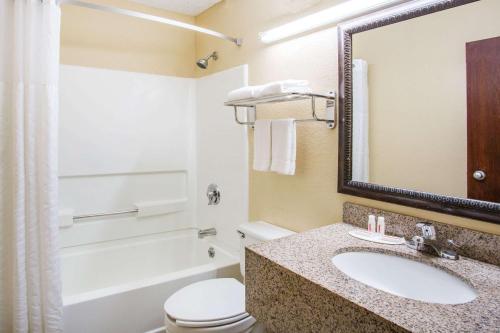 a bathroom with a sink and a toilet and a tub at Super 8 by Wyndham Harrisonburg in Harrisonburg