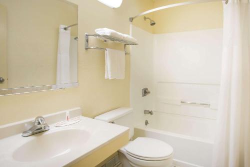 a white bathroom with a sink and a toilet at Super 8 by Wyndham Lexington VA in Lexington