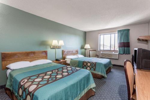 a hotel room with two beds and a television at Super 8 by Wyndham Richmond Midlothian Turnpike in Midlothian