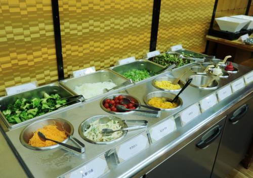 a buffet line with many different dishes of food at Uomisaki Hotel in Atami