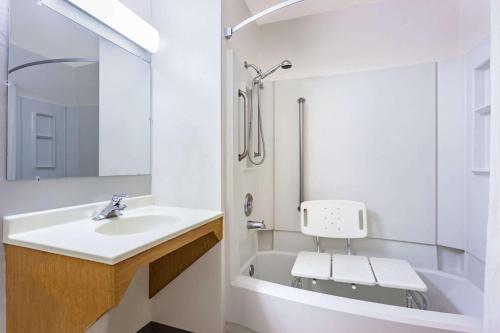 a bathroom with a sink and a bath tub at Super 8 by Wyndham Union Gap Yakima Area in Union Gap