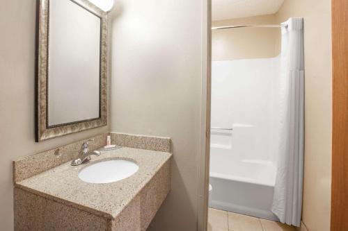 a bathroom with a sink and a shower at Super 8 by Wyndham Natchitoches in Natchitoches
