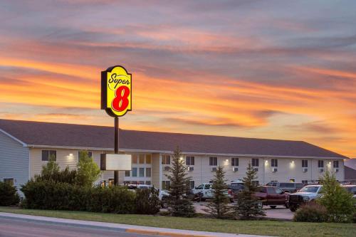 a sign for a mcdonalds in a parking lot at Super 8 by Wyndham Lewistown in Lewistown