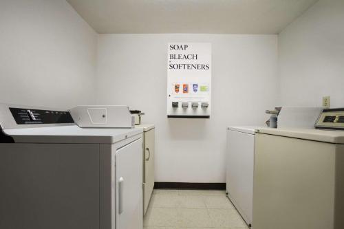 a kitchen with a counter and a dishwasher at Super 8 by Wyndham Port Angeles at Olympic National Park in Port Angeles