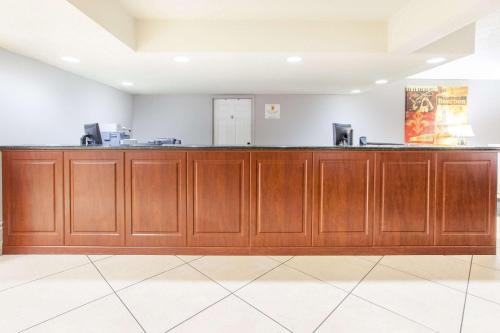 a bar in a room with wooden cabinets at Super 8 by Wyndham West Monroe in West Monroe