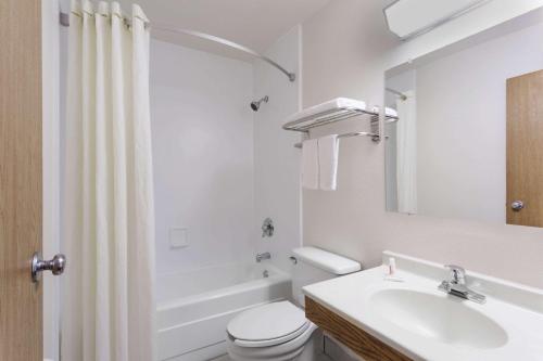 a white bathroom with a sink and a toilet at Super 8 by Wyndham Dumfries/Quantico in Dumfries