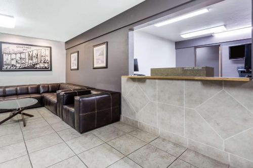 a waiting room with leather furniture and a counter at Super 8 by Wyndham Bremerton in Bremerton