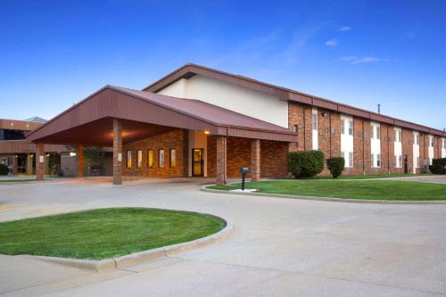 a large brick building with a driveway in front of it at Super 8 by Wyndham Tuscola in Tuscola