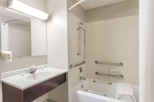 a bathroom with a sink and a toilet and a mirror at Super 8 by Wyndham St. Charles in Saint Charles