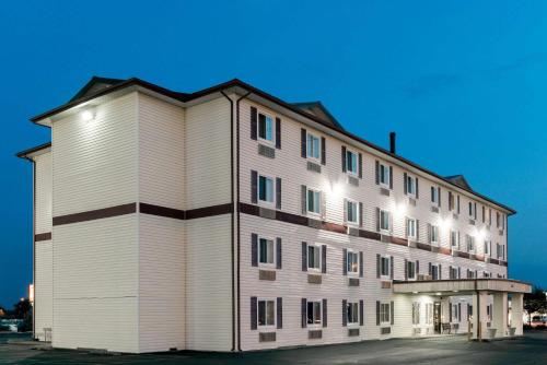 a large white building with a lot of windows at Super 8 by Wyndham Springfield East in Springfield