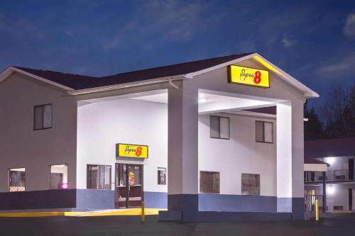 a gas station with a sign in front of it at Super 8 by Wyndham Locust Grove in Locust Grove