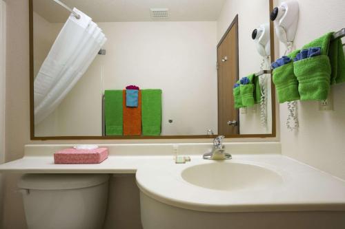 a bathroom with a sink and a mirror at Super 8 by Wyndham Las Vegas in Las Vegas