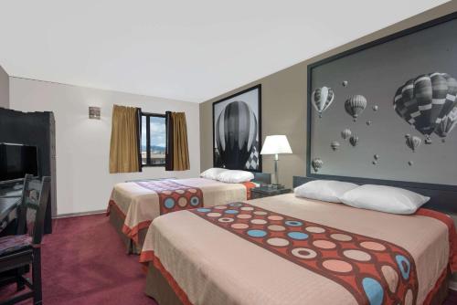 a hotel room with two beds and a tv at Super 8 by Wyndham Taos in Taos
