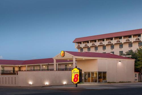 a gas station with a sign in front of it at Super 8 by Wyndham Lubbock Civic Center North in Lubbock