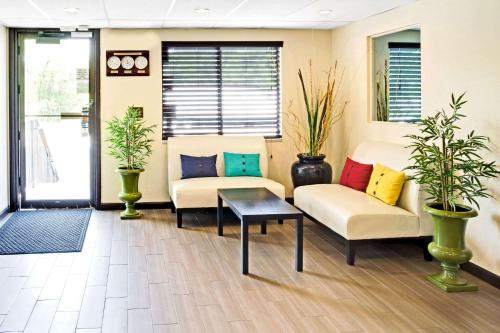 a living room with two couches and a table at Super 8 by Wyndham Ogden, Utah in Ogden