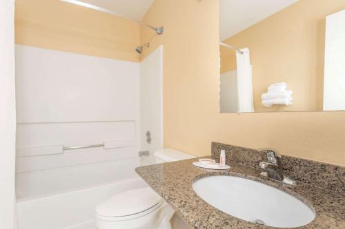 a bathroom with a sink and a toilet and a mirror at Super 8 by Wyndham Nephi in Nephi