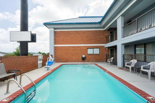 a swimming pool on the patio of a building at Super 8 by Wyndham Dandridge in Dandridge