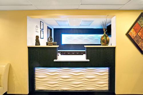 a lobby with a large screen in a room at Super 8 by Wyndham Ogden, Utah in Ogden