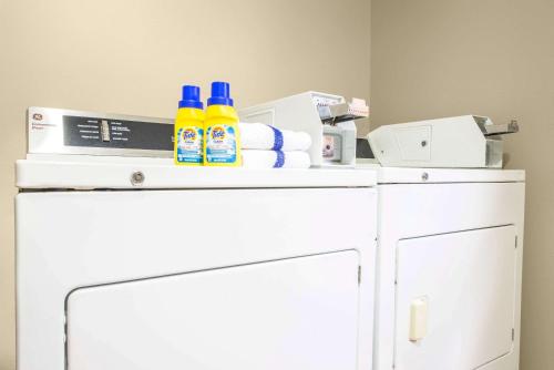a white refrigerator with cleaning products on top of it at Super 8 by Wyndham Grants in Grants